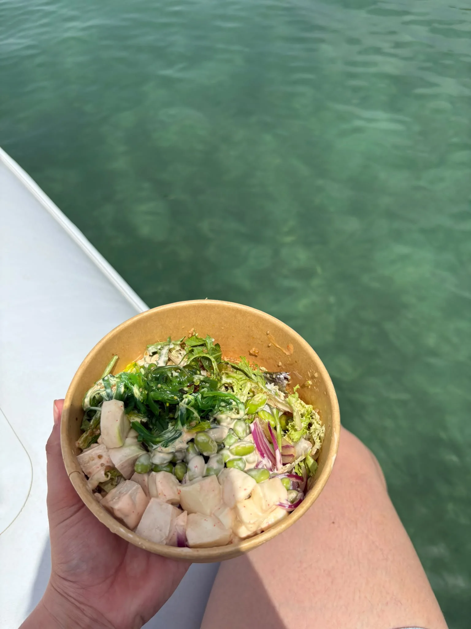 Fresh poke bowl from Pinsi's Picnic enjoyed on a boat Fresh poke bowl from Pinsi's Picnic enjoyed on a boat